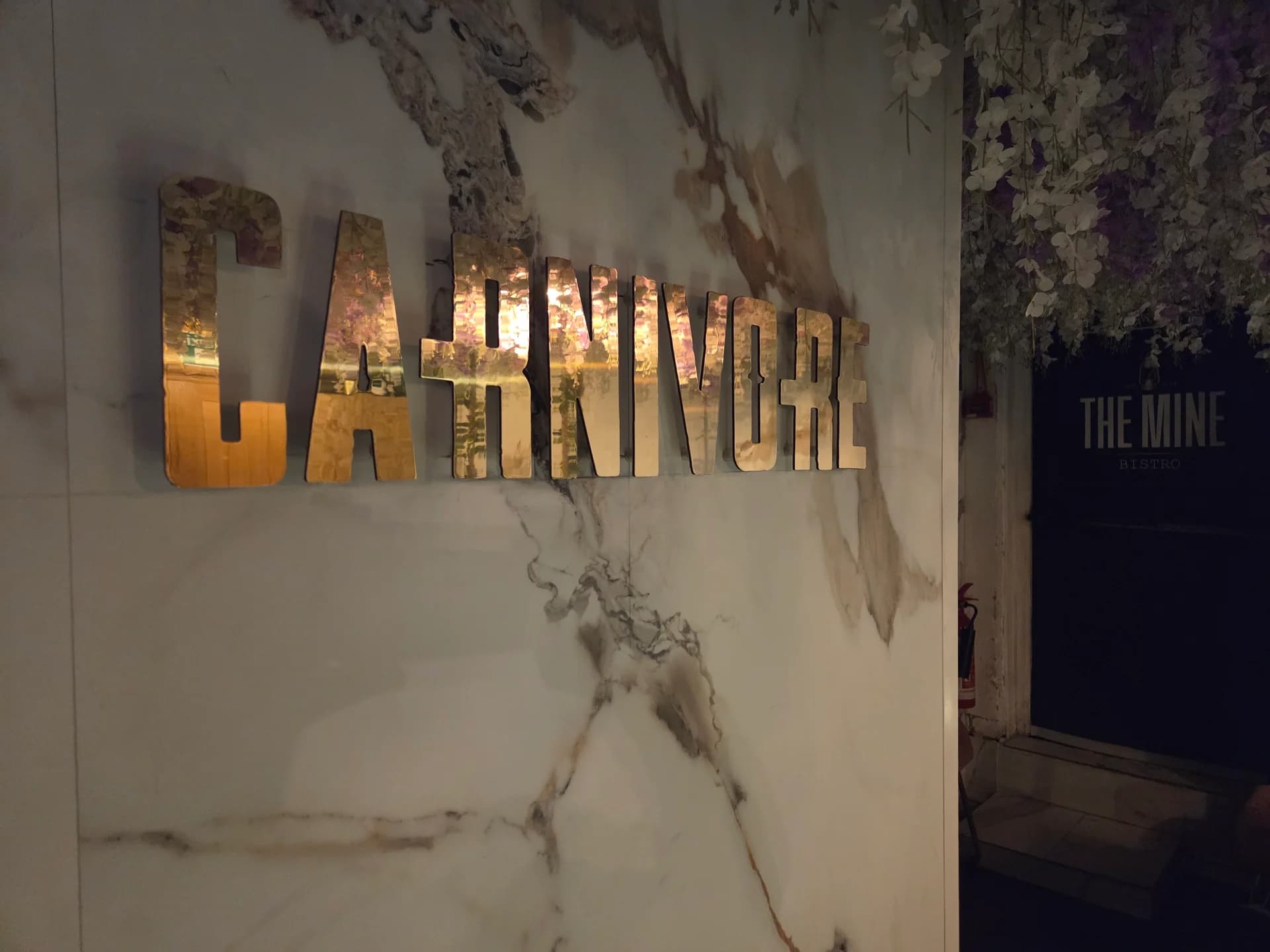 Gold neon signage at The Carnivore